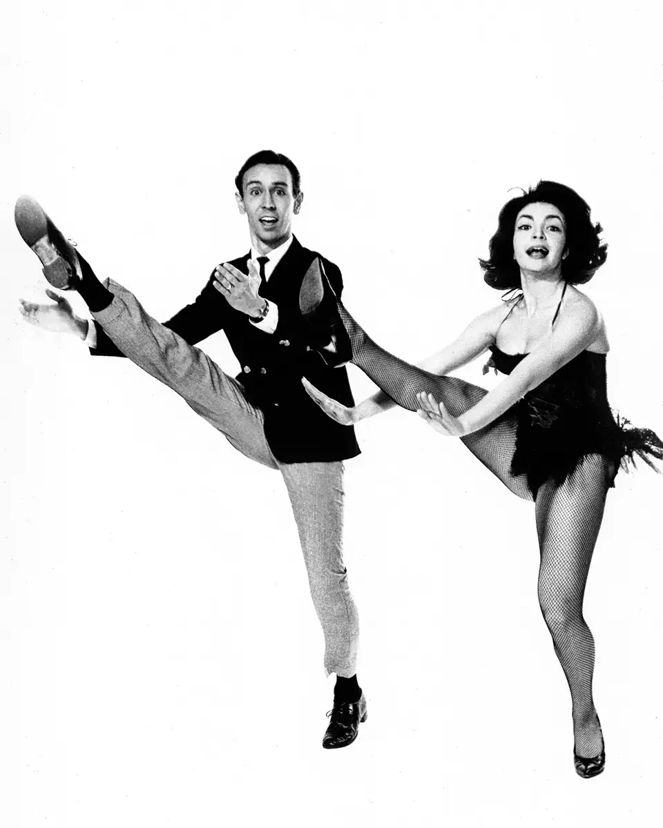 Dean and a partner mid-kick