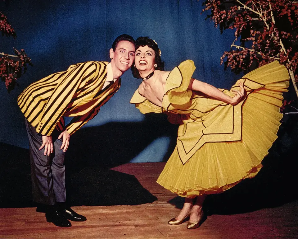 Dean and a partner in costume, taking a bow