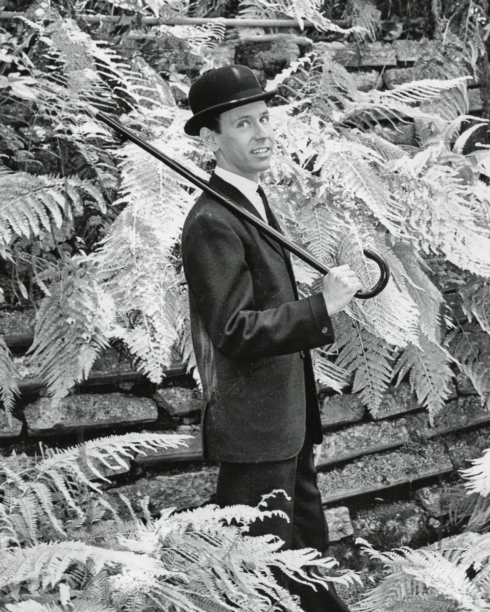 Young Dean in a derby among the ferns, a cane over his shoulder
